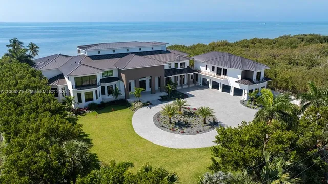 an aerial view of a house with a ocean view