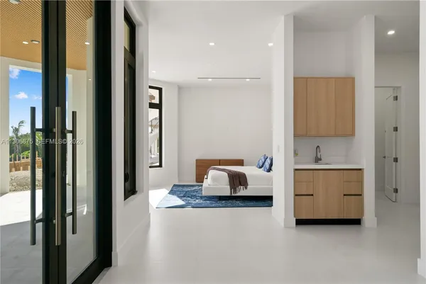 a view of a room with wooden floor and white walls