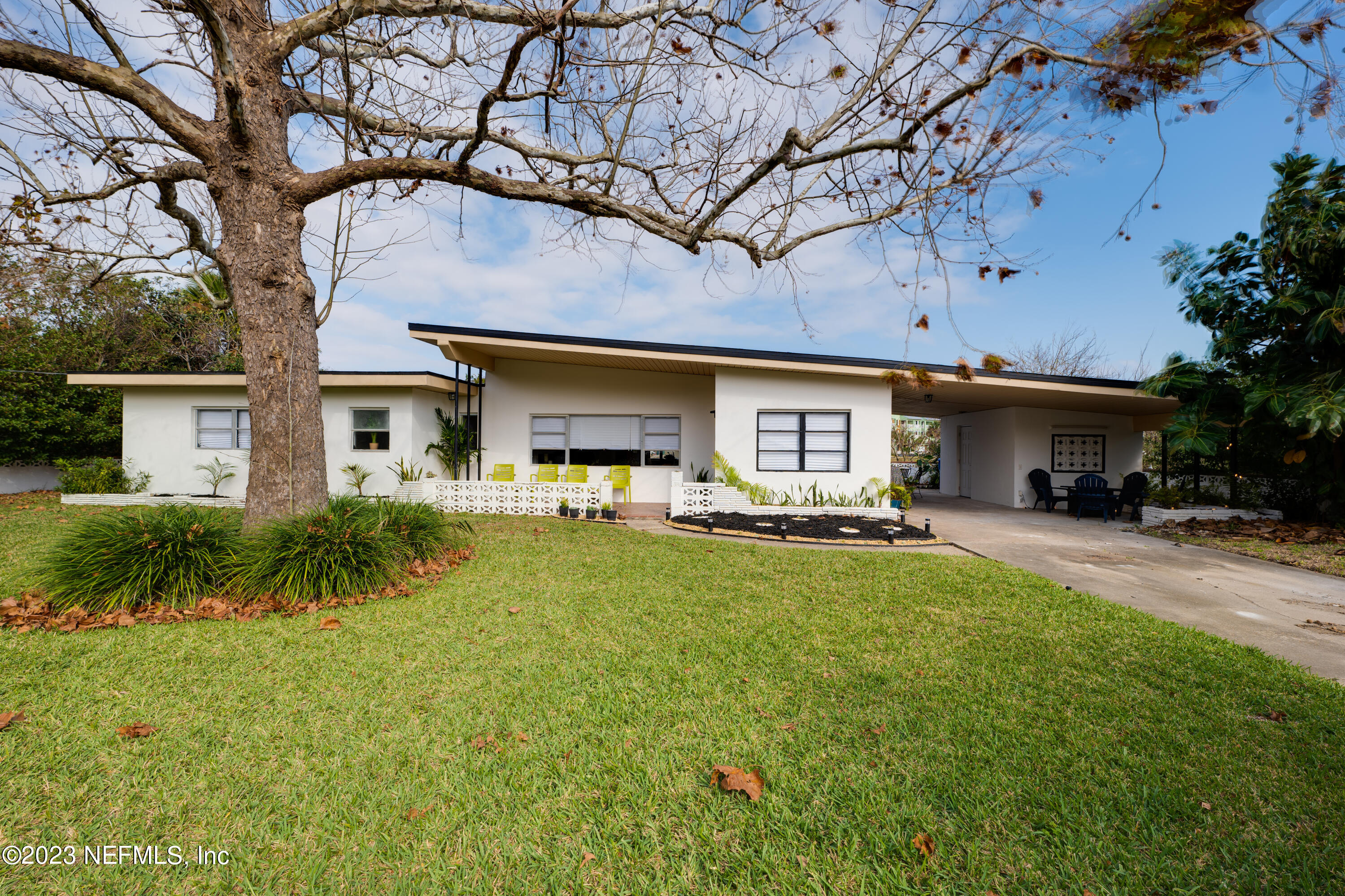 140 Ferrol Road St. Augustine, FL 32084 - Photo 1 of 27 a front view of a house with a porch and a yard