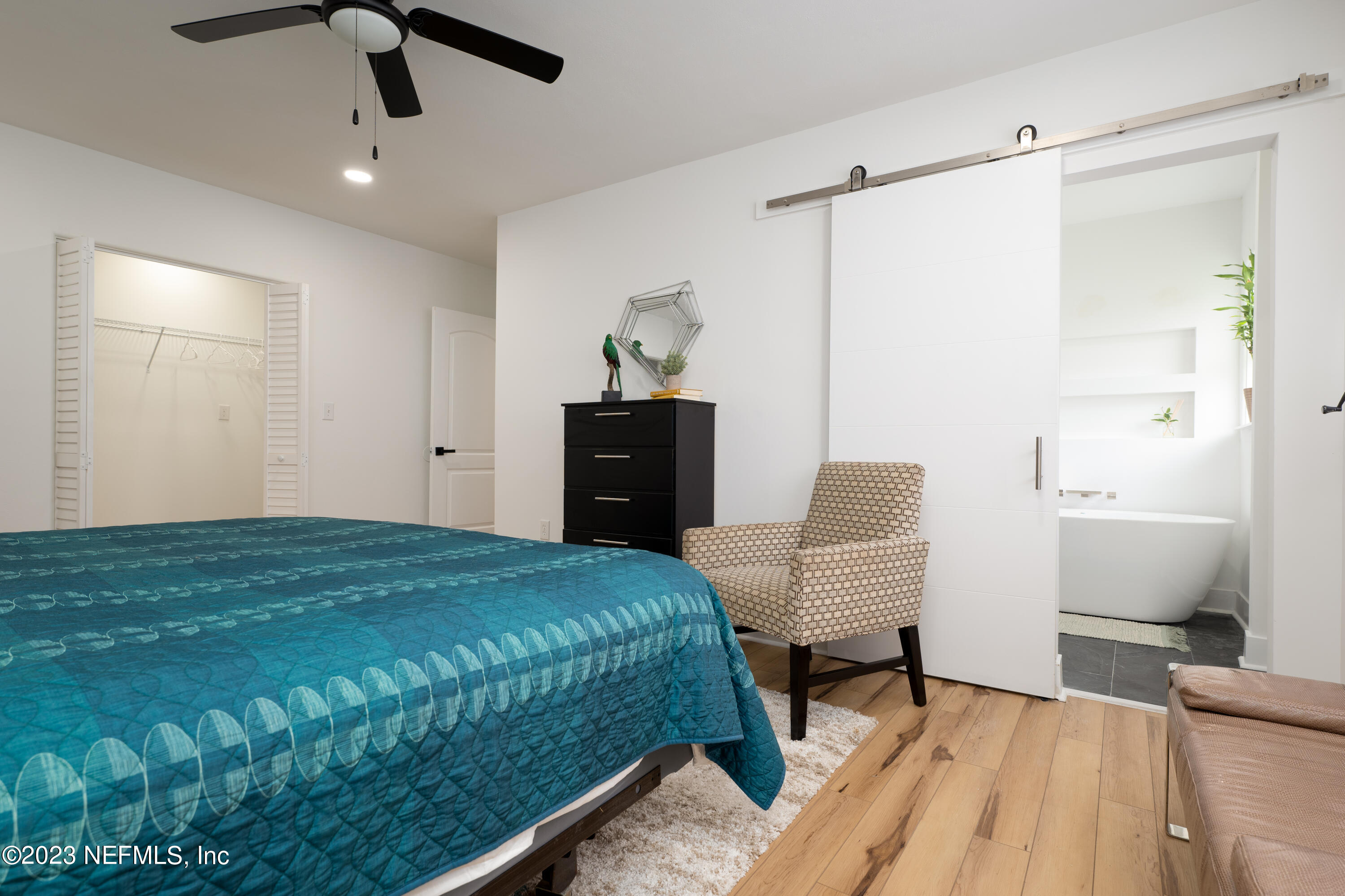 140 Ferrol Road St. Augustine, FL 32084 - Photo 17 of 27 a bedroom with a bed and a chair