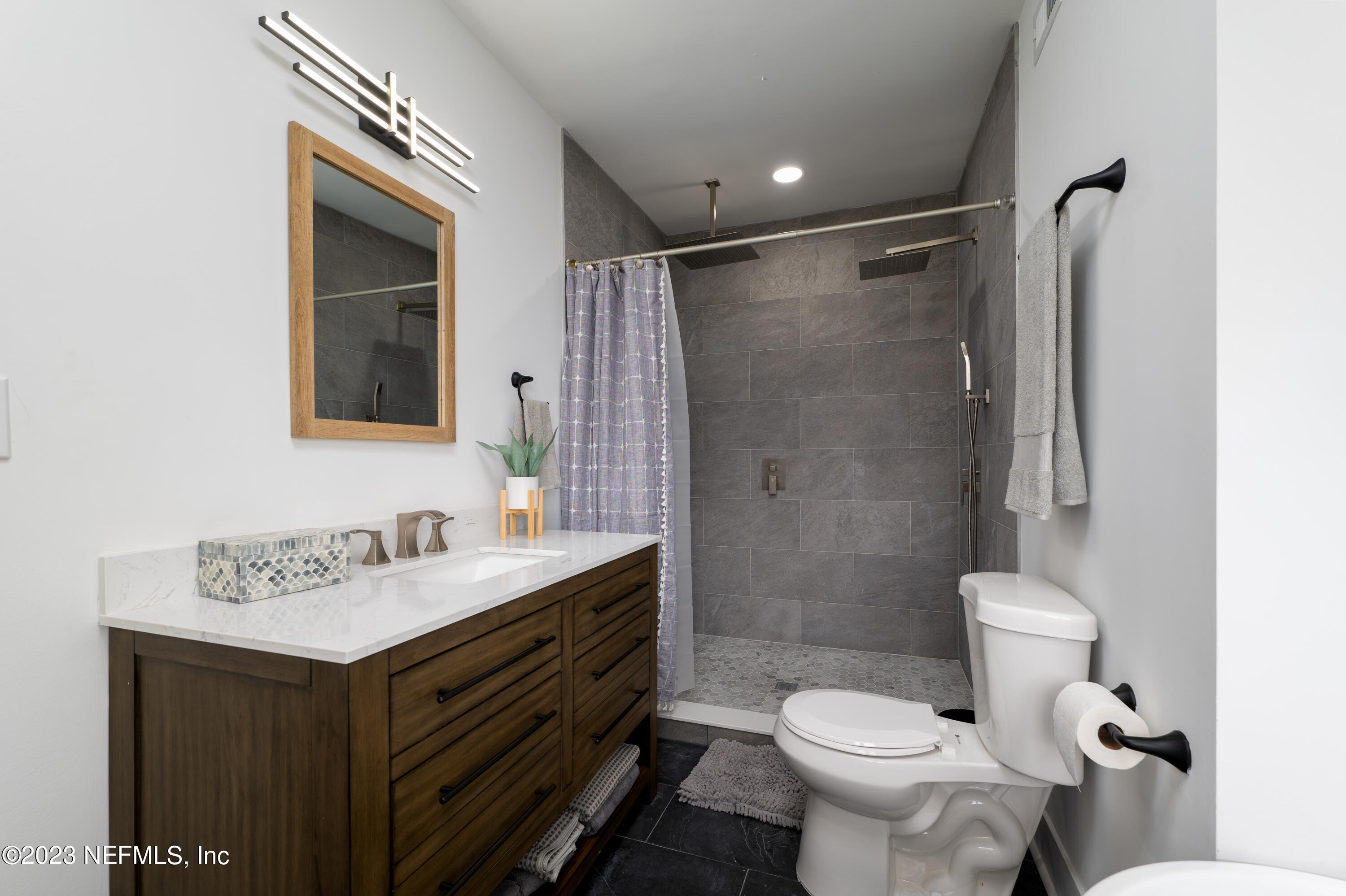 140 Ferrol Road St. Augustine, FL 32084 - Photo 19 of 27 a bathroom with a sink toilet vanity and shower