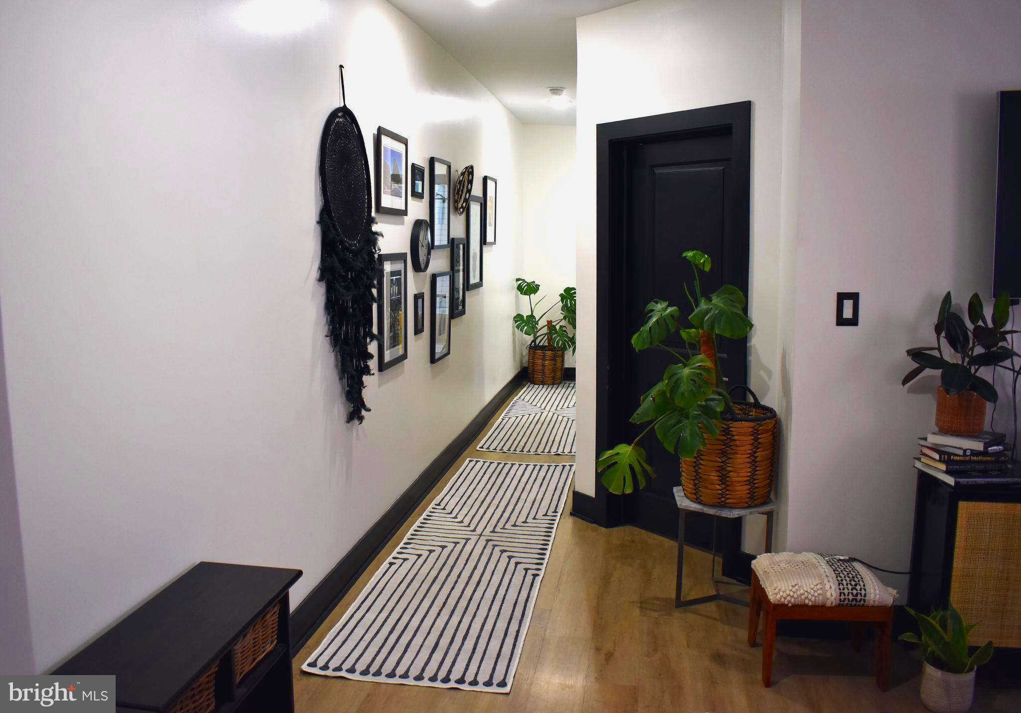 5310 Spruce Street, Unit 2 Philadelphia, PA 19139 - Photo 16 of 19 a hallway with a potted plant and wooden floor