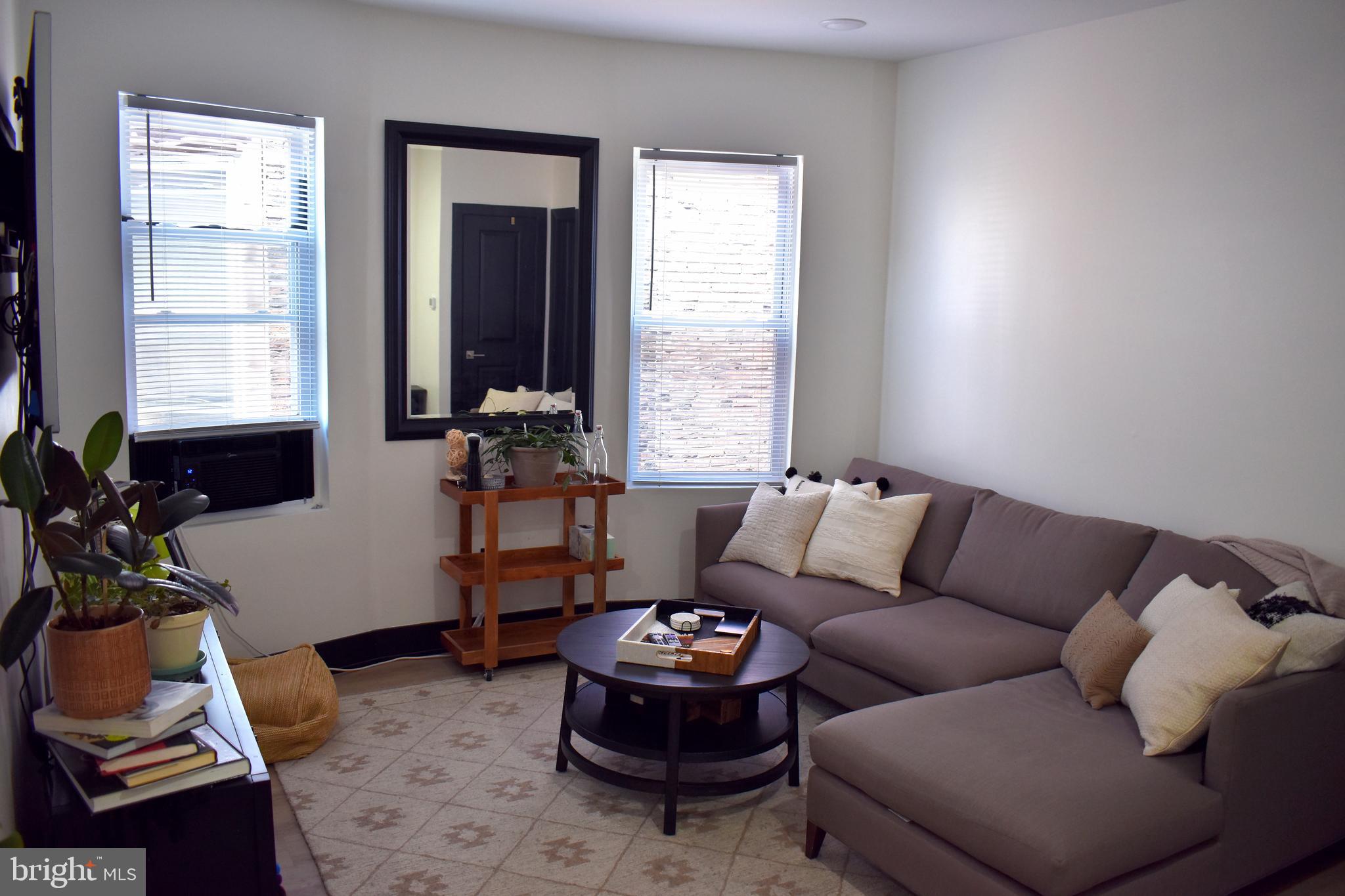 5310 Spruce Street, Unit 2 Philadelphia, PA 19139 - Photo 17 of 19 a living room with furniture and a large window