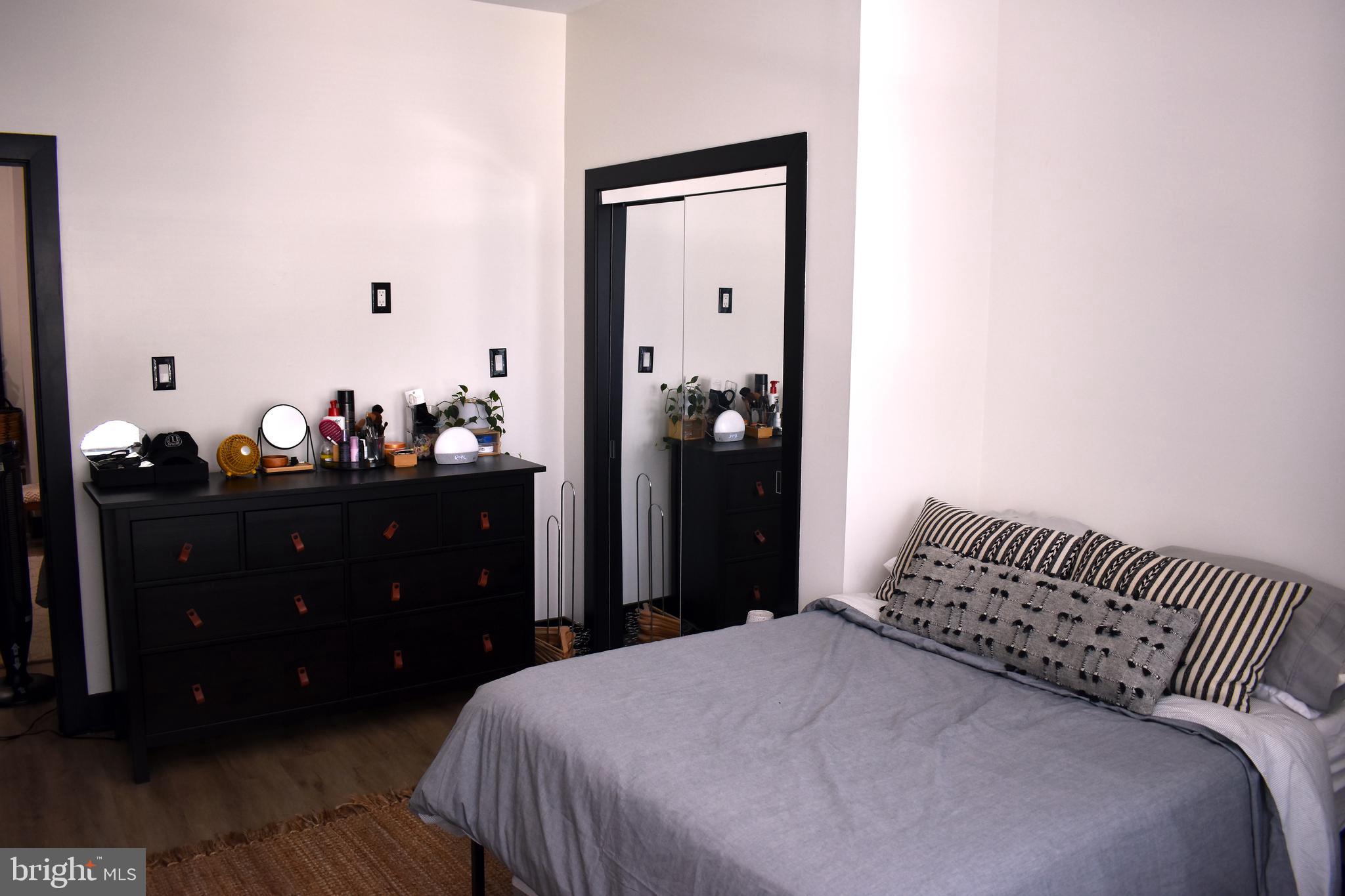 5310 Spruce Street, Unit 2 Philadelphia, PA 19139 - Photo 19 of 19 a bedroom with a bed and a mirror