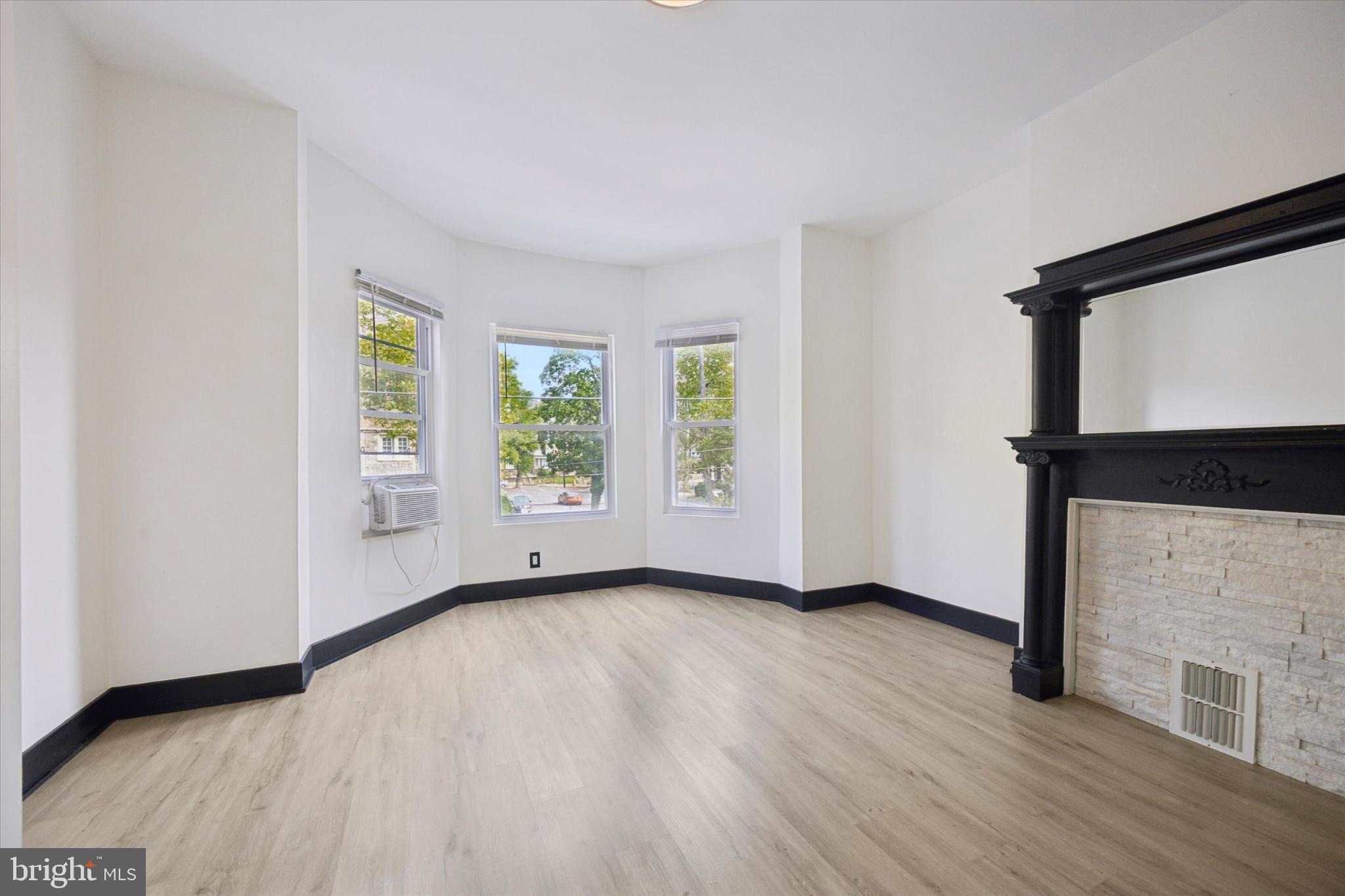 5310 Spruce Street, Unit 2 Philadelphia, PA 19139 - Photo 2 of 19 a view of an empty room with wooden floor and a window