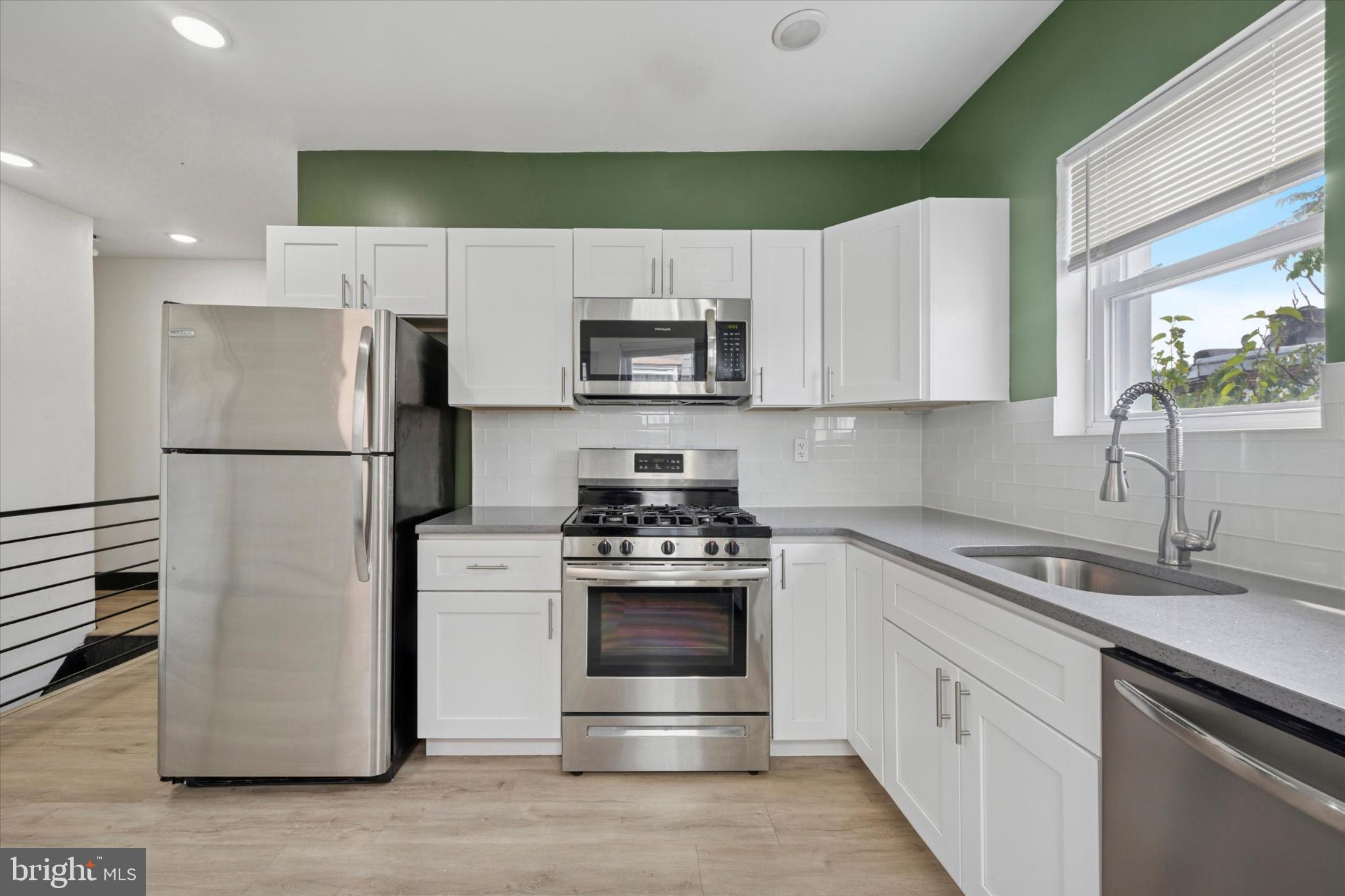 5310 Spruce Street, Unit 2 Philadelphia, PA 19139 - Photo 4 of 19 a kitchen with stainless steel appliances a refrigerator sink and microwave