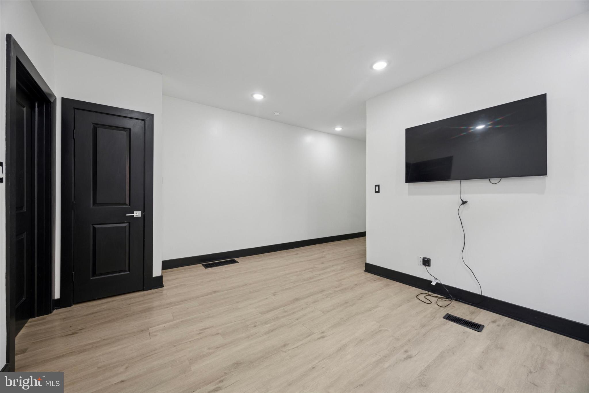 5310 Spruce Street, Unit 2 Philadelphia, PA 19139 - Photo 10 of 19 a view of an empty room with wooden floor and white walls