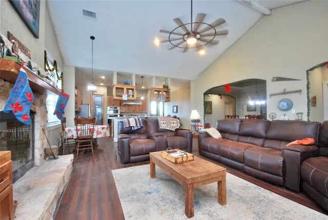 a living room with furniture and a chandelier