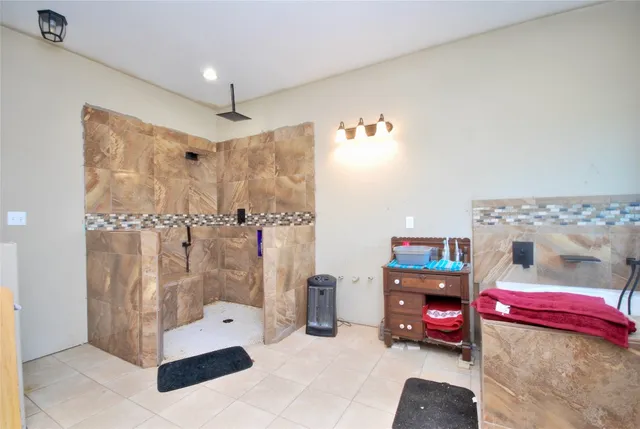 a bedroom with furniture and a shower