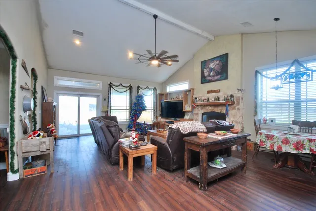 a living room with furniture a fireplace and a flat screen tv