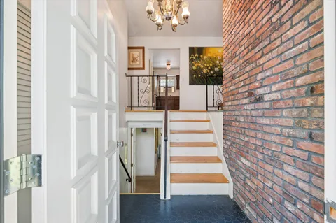 a view of entryway with wooden floor and a chandelier