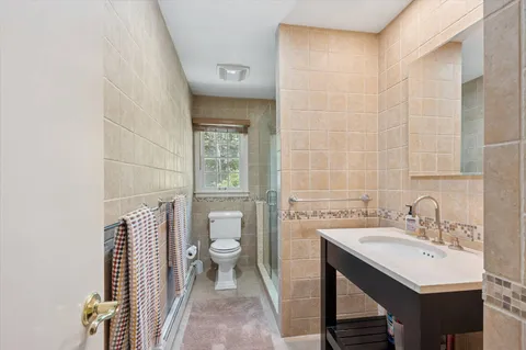 a bathroom with a sink a toilet and a mirror