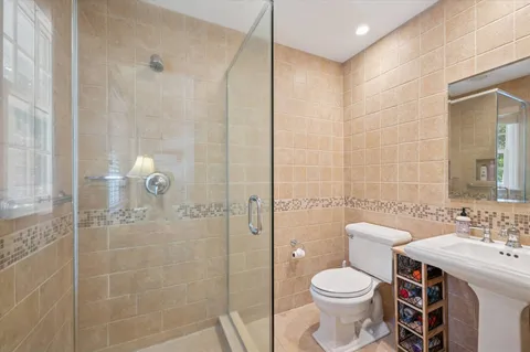 a bathroom with a sink toilet and shower