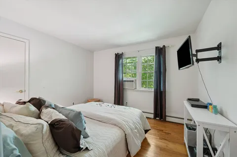 a bed sitting in a bedroom next to a window