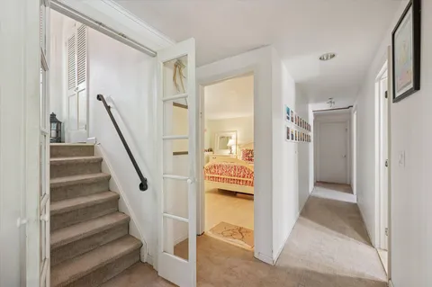 a view of a hallway with an entryway and livingroom