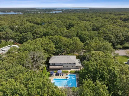 an aerial view of a house with a yard