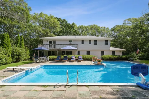 a front view of house with yard outdoor seating and barbeque oven