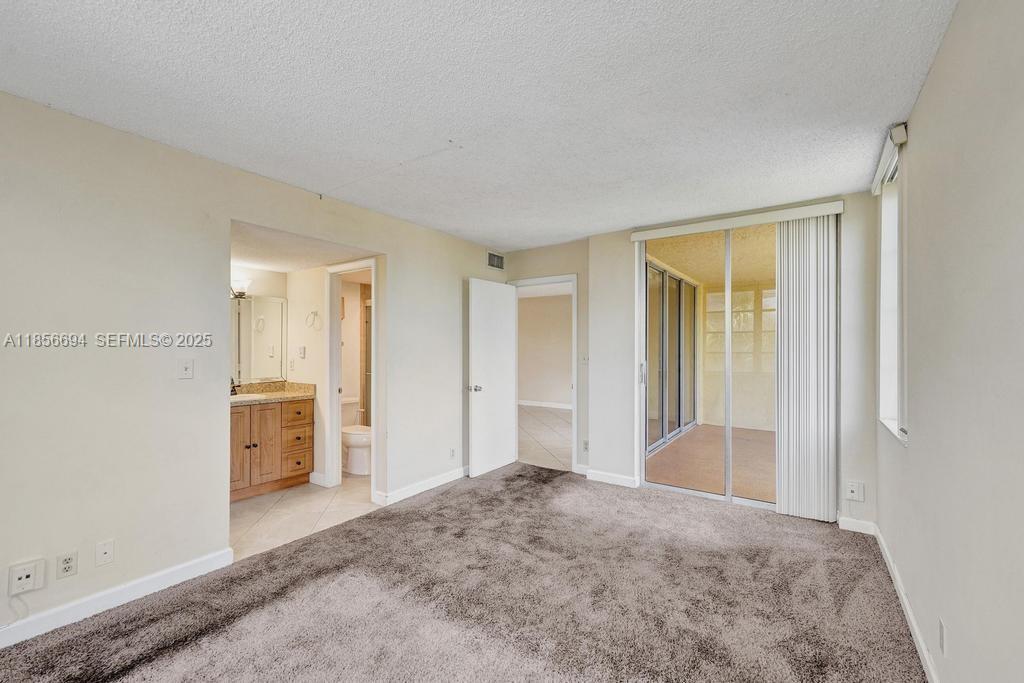 9520 Seagrape Drive, Unit 306 Davie, FL 33324 - Photo 14 of 20 a view of hallway with bathroom and bathroom