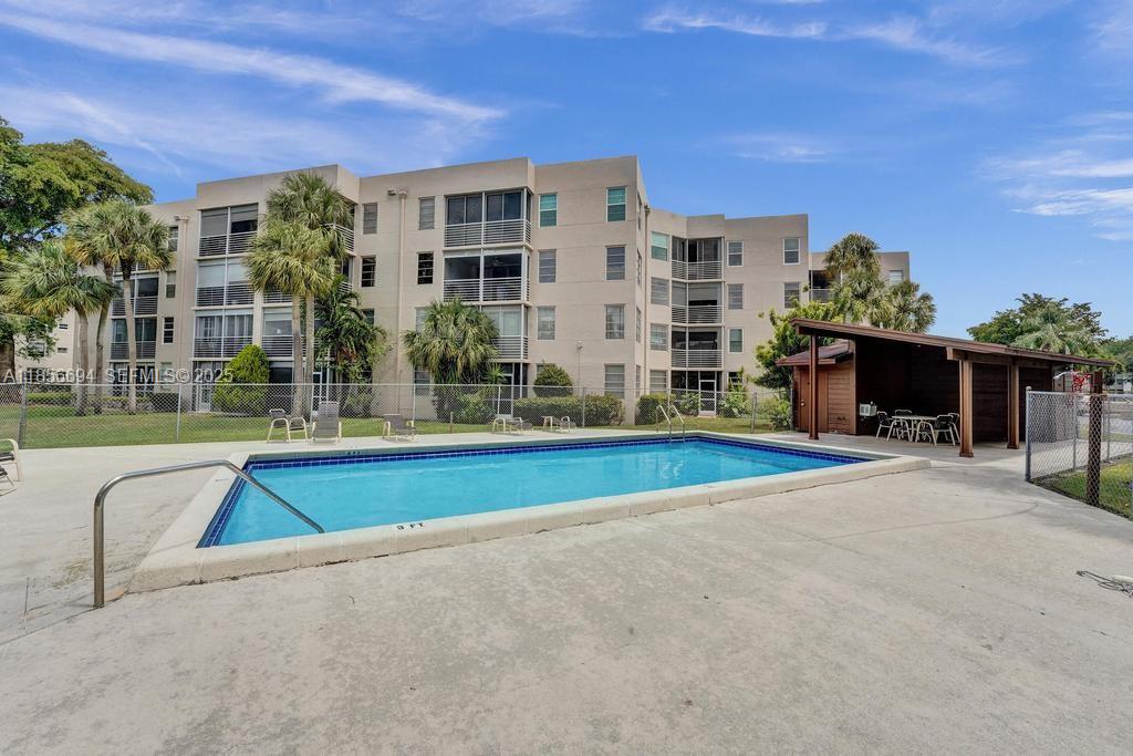 9520 Seagrape Drive, Unit 306 Davie, FL 33324 - Photo 20 of 20 a view of a building with a swimming pool