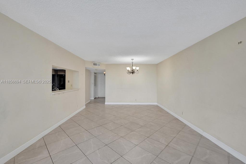 9520 Seagrape Drive, Unit 306 Davie, FL 33324 - Photo 7 of 20 an empty room with chandelier fan