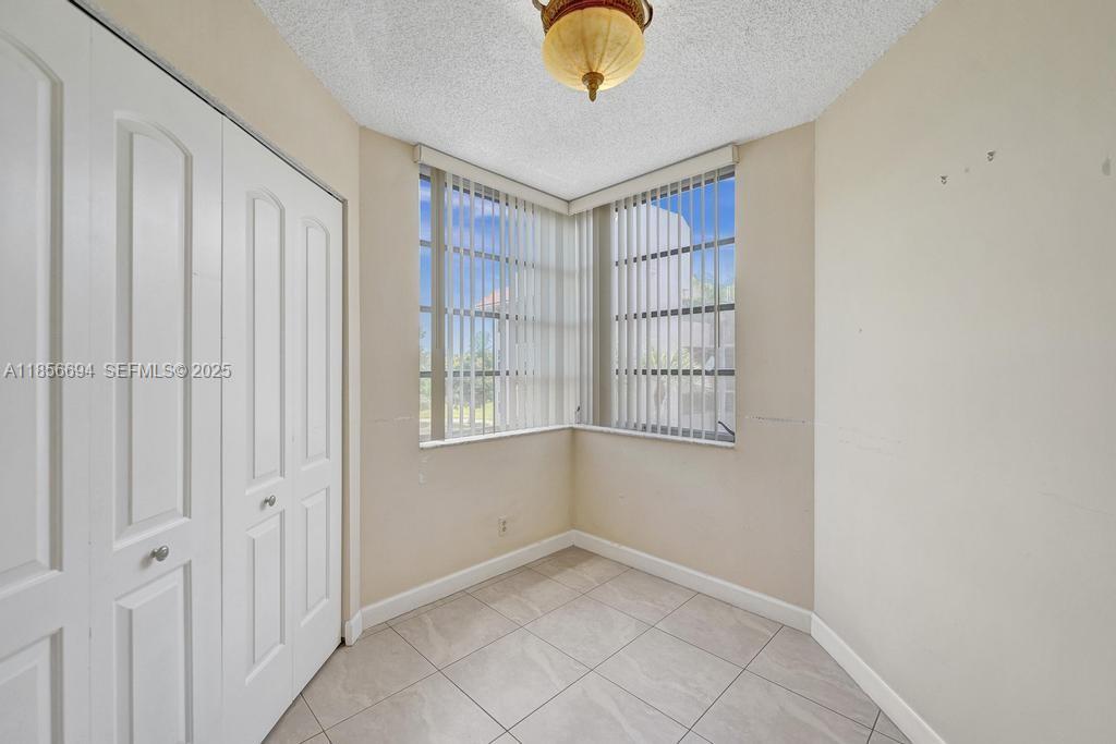 9520 Seagrape Drive, Unit 306 Davie, FL 33324 - Photo 10 of 20 an empty room with windows