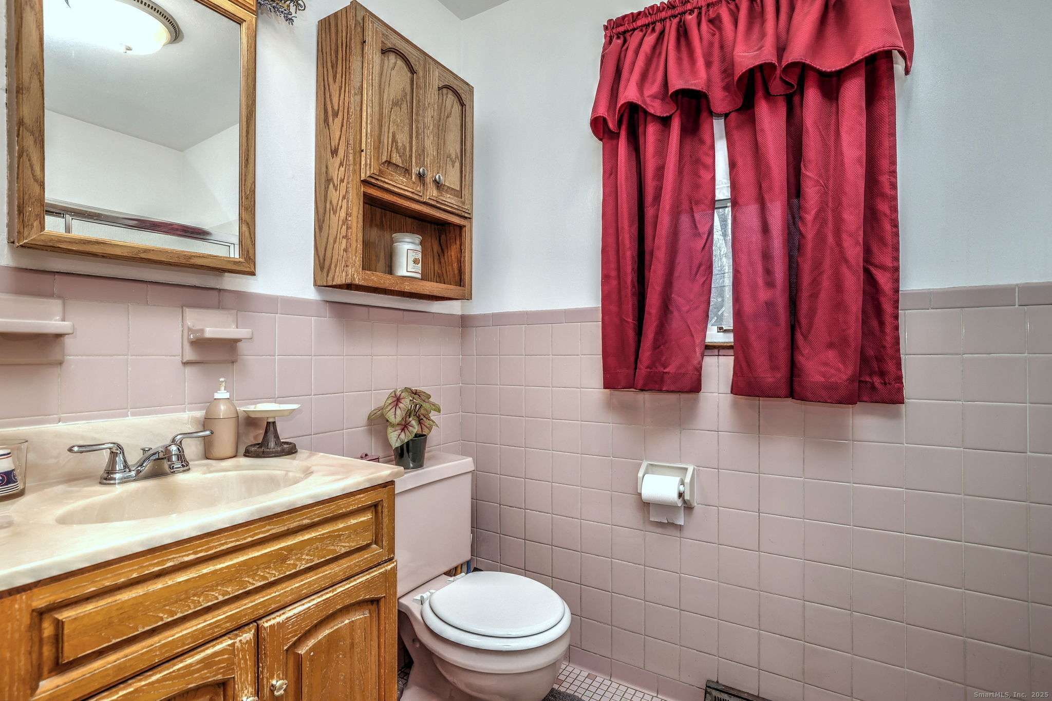 15 Utica Street Milford, CT 06461 - Photo 24 of 39 a bathroom with a sink a toilet and shower curtain