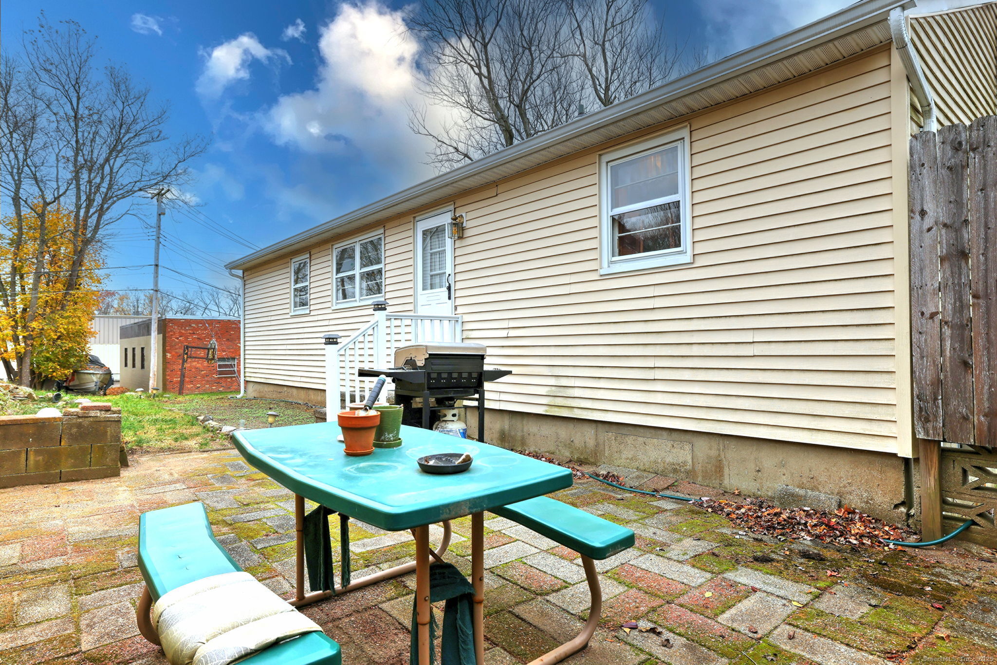 15 Utica Street Milford, CT 06461 - Photo 5 of 39 a backyard of a house with table and chairs