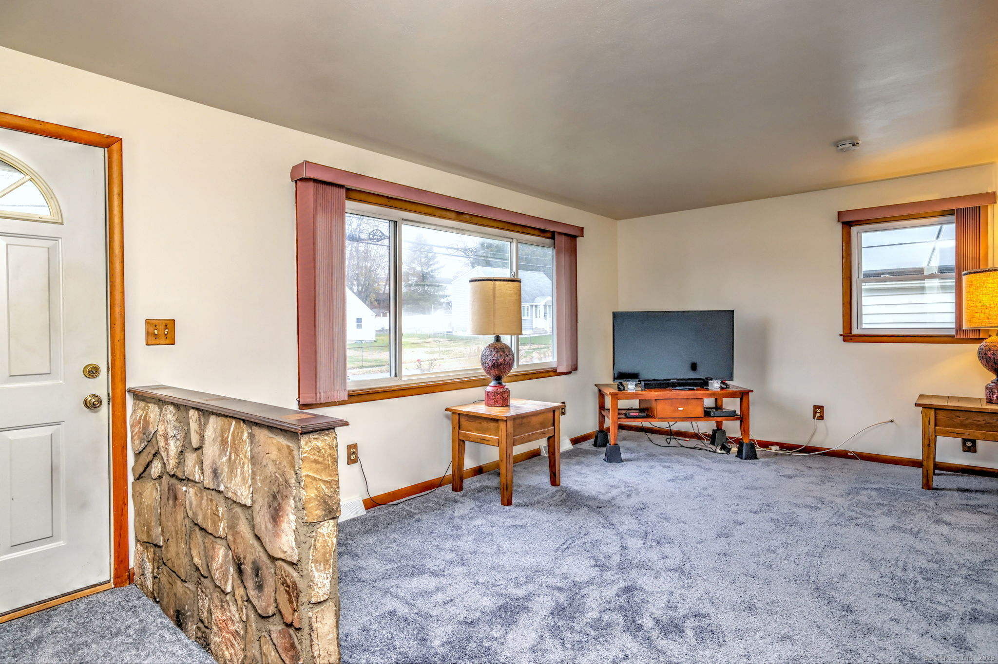 15 Utica Street Milford, CT 06461 - Photo 9 of 39 a living room with furniture a flat screen tv and a window
