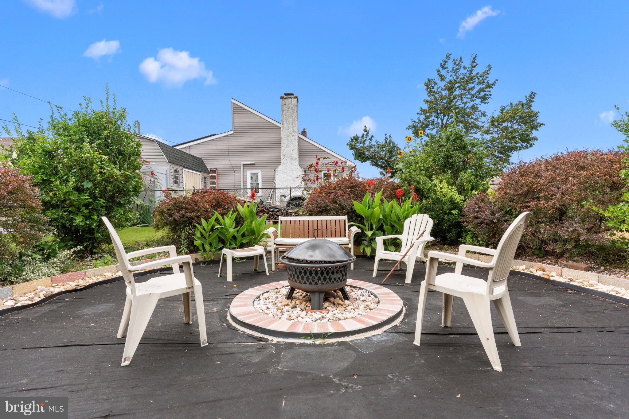 67 Greenbriar Road Levittown, PA 19057 - Photo 19 of 24 a view of a chair and table in backyard