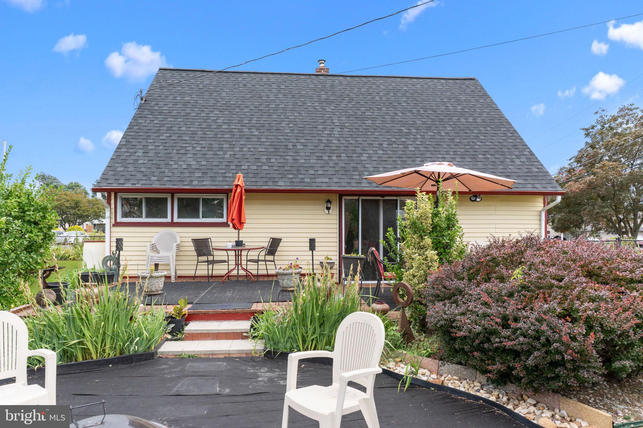 67 Greenbriar Road Levittown, PA 19057 - Photo 20 of 24 a patio with table and chairs and potted plants