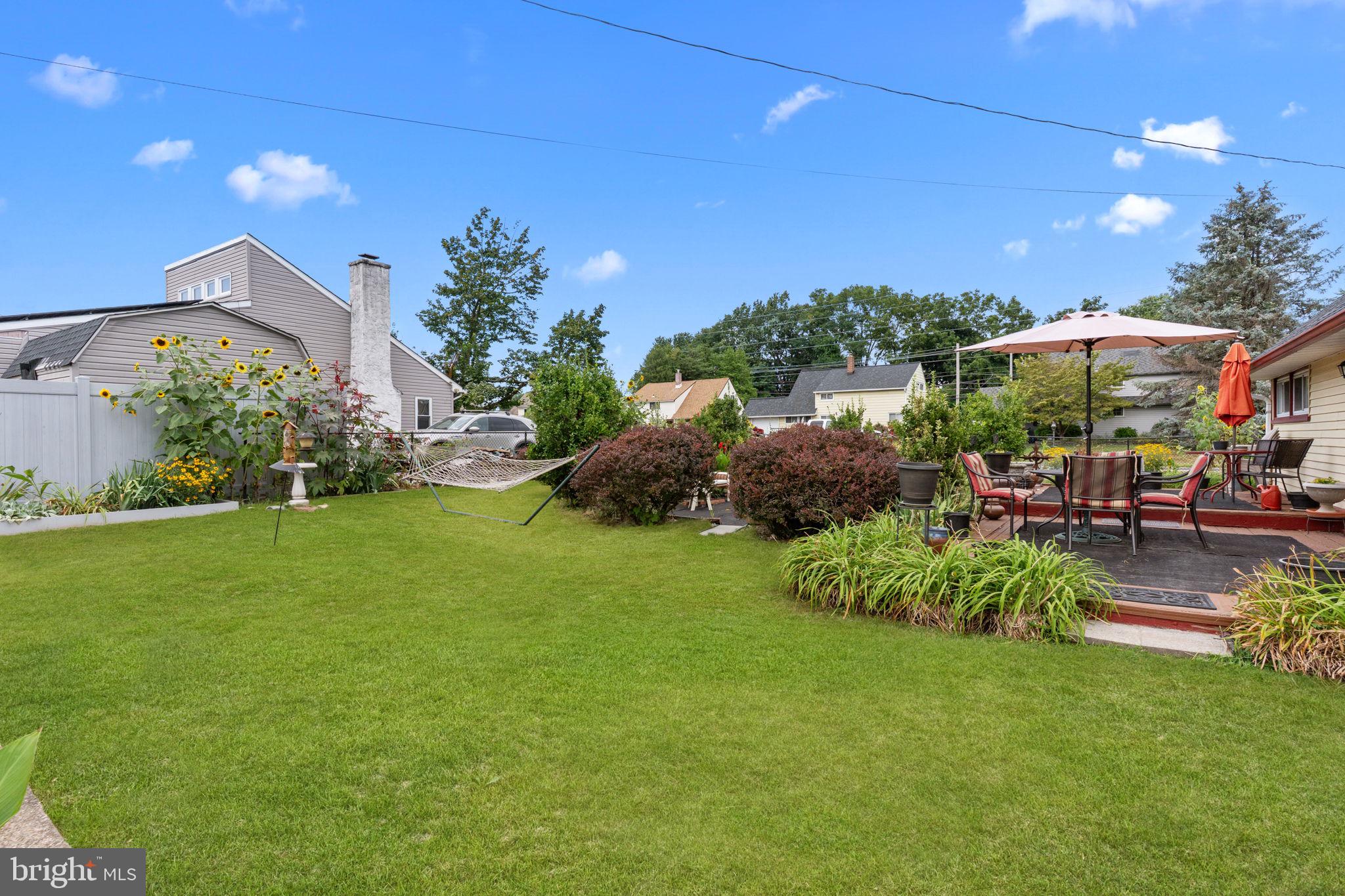 67 Greenbriar Road Levittown, PA 19057 - Photo 22 of 24 a view of a patio with table and chairs potted plants