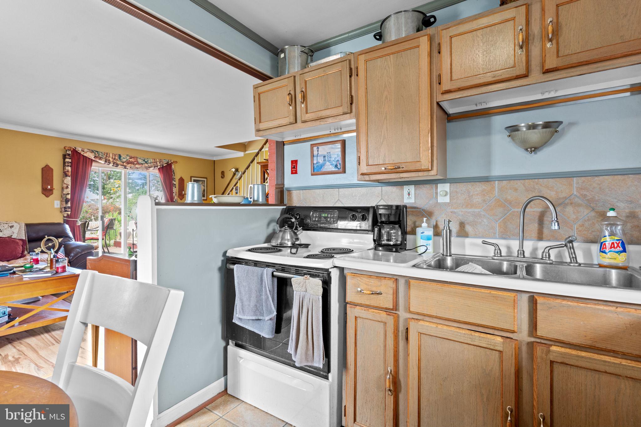 67 Greenbriar Road Levittown, PA 19057 - Photo 8 of 24 a kitchen with stainless steel appliances granite countertop a sink stove and cabinets