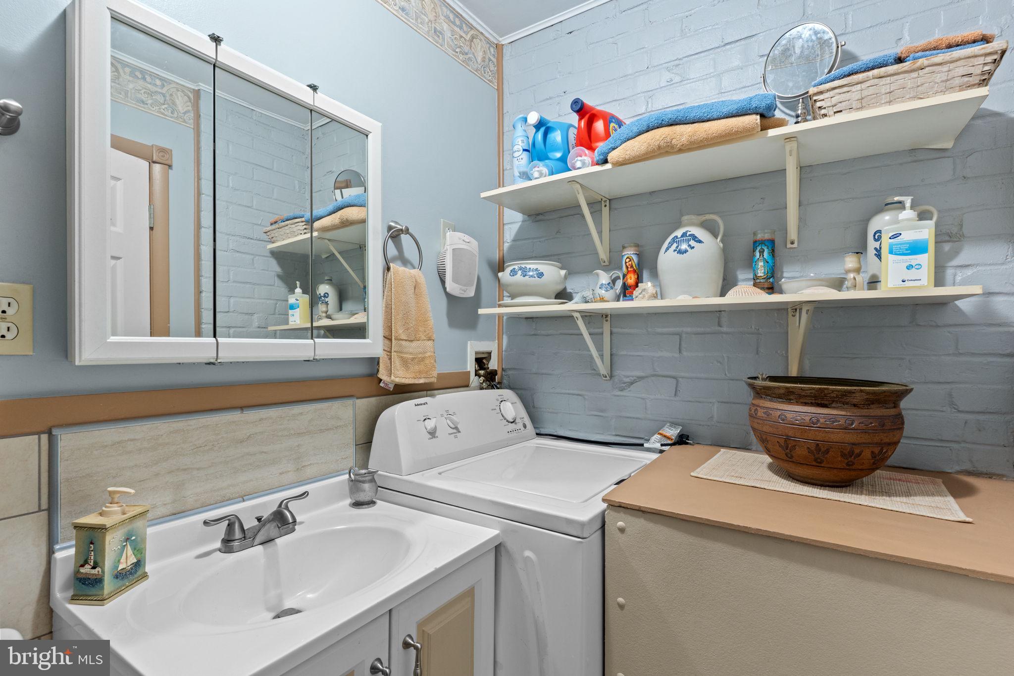 67 Greenbriar Road Levittown, PA 19057 - Photo 10 of 24 a bathroom with a sink and a mirror