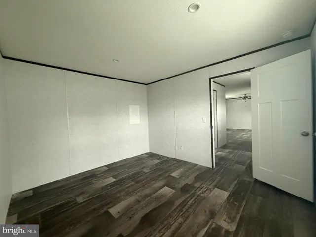 a bathroom with a granite countertop toilet and a sink