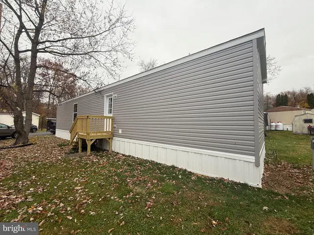 a kitchen that has a lot of cabinets and wooden floor