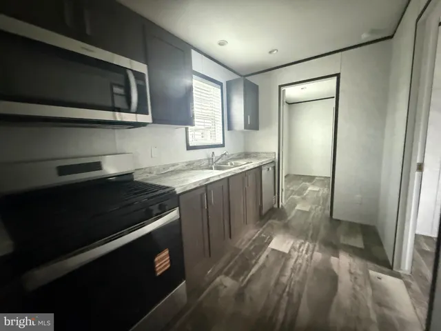 a kitchen with a sink stove and refrigerator