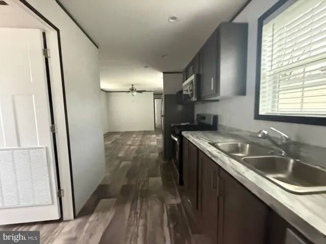 a kitchen with stainless steel appliances a refrigerator a stove a sink and a refrigerator