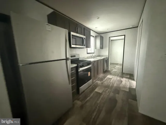 a view of a livingroom with a ceiling fan and window