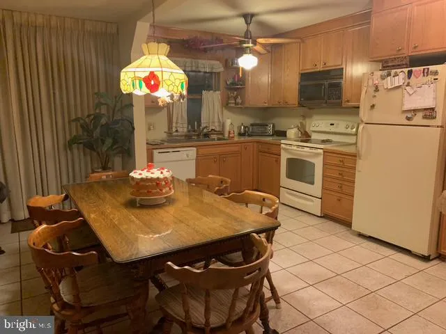a kitchen with a table chairs and a refrigerator