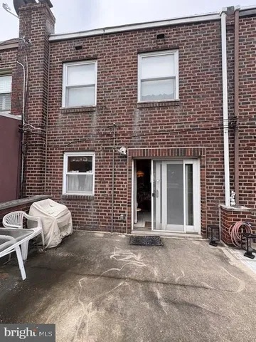 a view of a brick house with many windows