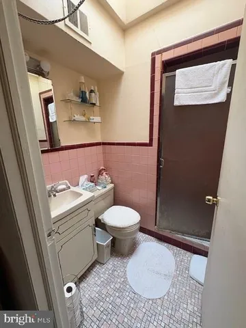a bathroom with a toilet a sink and shower