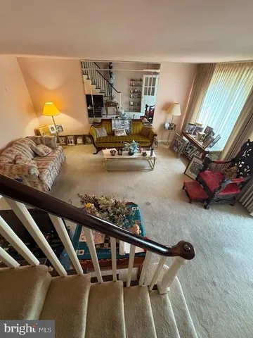 a view of a livingroom with furniture and a floor to ceiling window