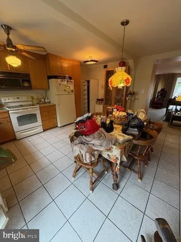 a kitchen with a sink dishwasher and a stove with a dining table