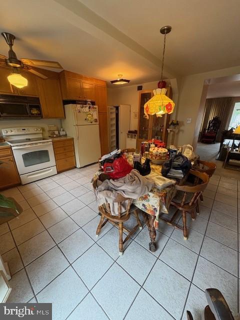 3107 South 13th Street Philadelphia, PA 19148 - Photo 10 of 35 a kitchen with a sink dishwasher and a stove with a dining table