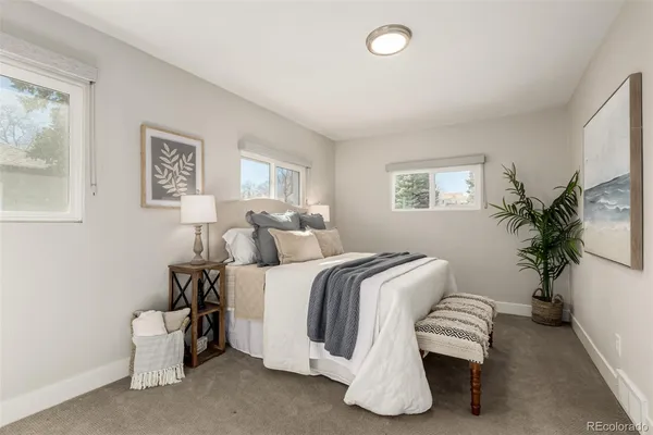 a bedroom with bed and a potted plant
