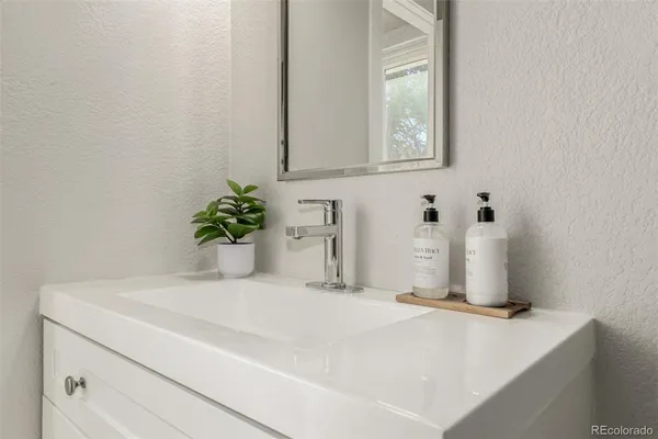 a bathroom with a sink a vanity and a mirror