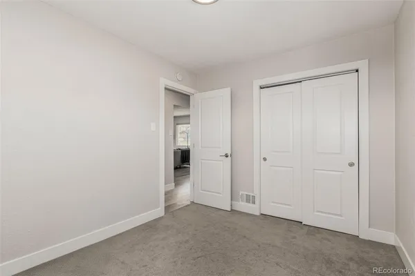 a view of a hallway with furniture and entryway