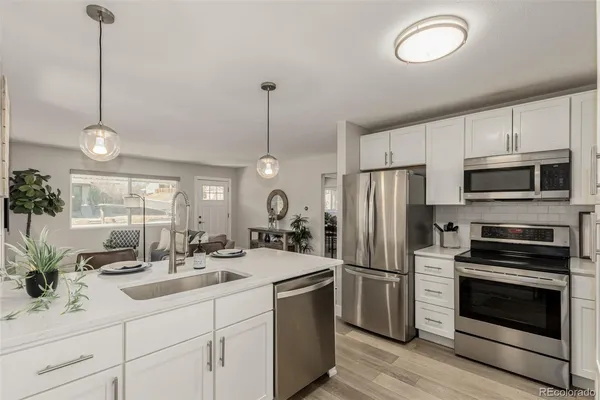 a kitchen with a sink stainless steel appliances and cabinets