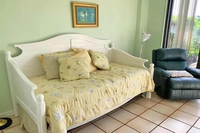 a large bed sitting in a bedroom next to a window