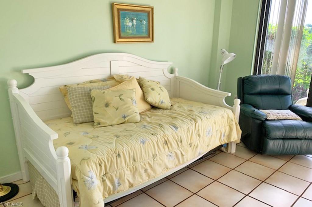 180 Seaview Court, Unit 111 Marco Island, FL 34145 - Photo 12 of 24 a large bed sitting in a bedroom next to a window